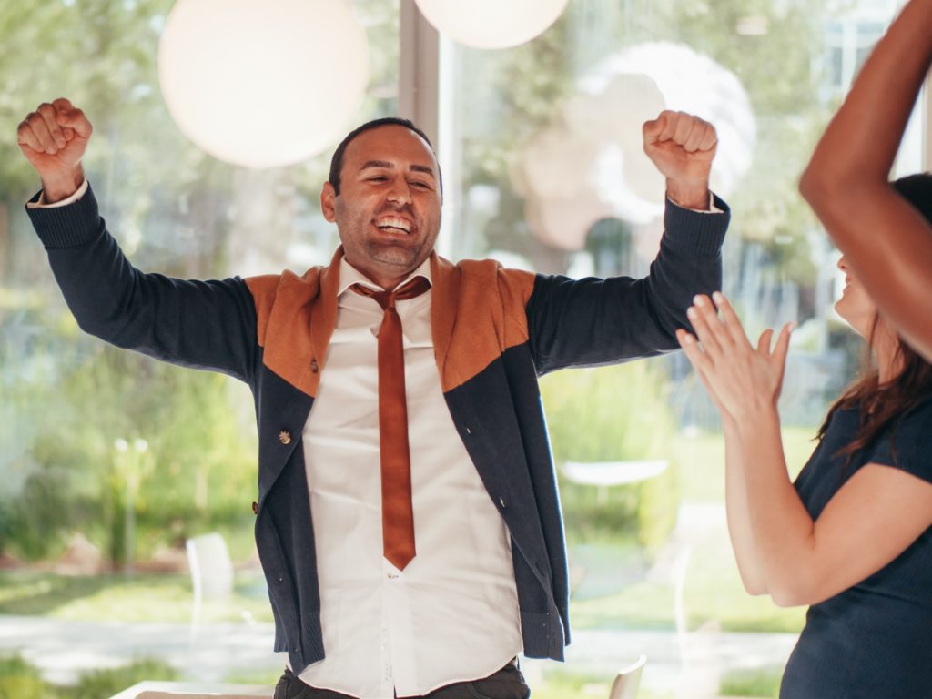 man excited that he passed his piano lesson book